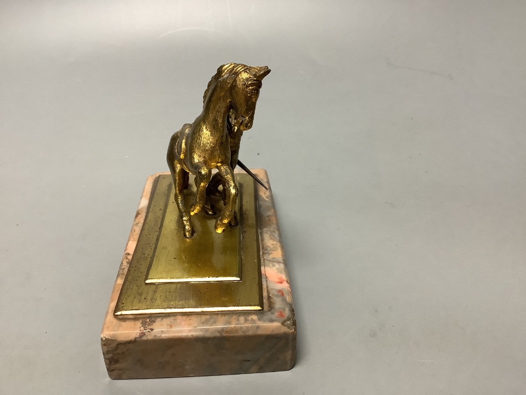 An early 20th century gilt metal group of a horse and jockey, on marble base, length 13cm